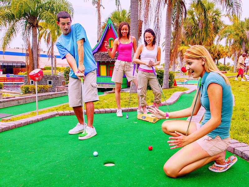Family playing Miniature Golf